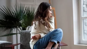 Concerned woman sits deep in thought