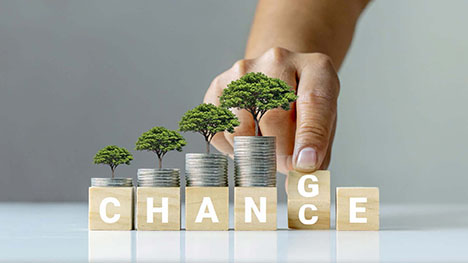 Cubes spelling the word Change with Coins and Trees On Top