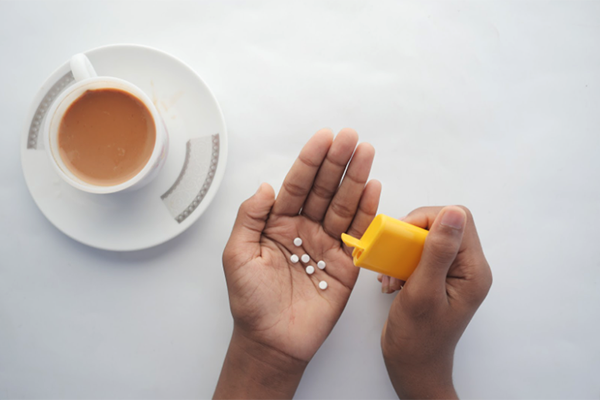 Small White Prescription Medication Dumped into Hands