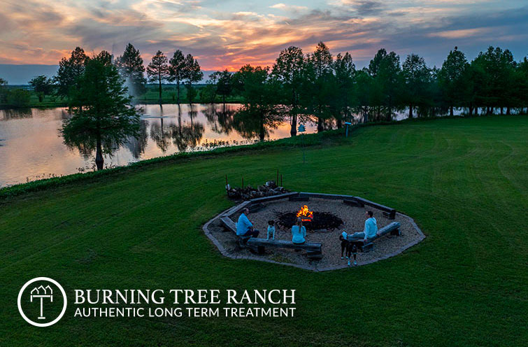 Bonfire beside the lake at Burning Tree Ranch at sunset