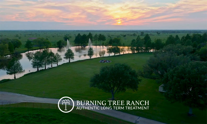 Sunset over the lake and fountain at Burning Tree Ranch